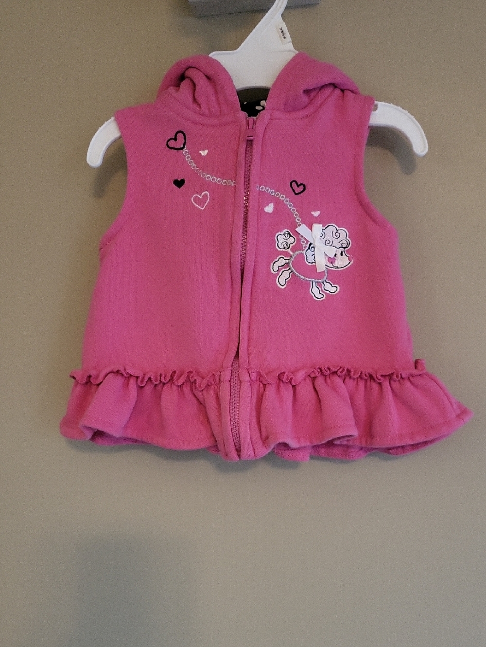 Pink hooded ruffle vest with embrodiered poodle